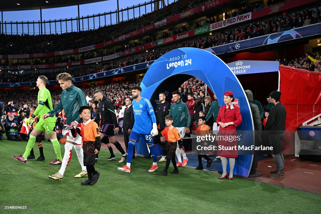 Martin Odegaard of Arsenal leads his team out prior to the <strong><a  data-cke-saved-href='https://www.vavel.com/en-us/soccer/2024/03/06/1175020-kylian-mbappe-brace-fires-psg-into-quarter-finals.html' href='https://www.vavel.com/en-us/soccer/2024/03/06/1175020-kylian-mbappe-brace-fires-psg-into-quarter-finals.html'>UEFA Champions League</a></strong> quarter-final first leg match between Arsenal FC and FC Bayern München at Emirates Stadium on April 09, 2024 in London, England. (Photo by Stuart MacFarlane/Arsenal FC via Getty Images)