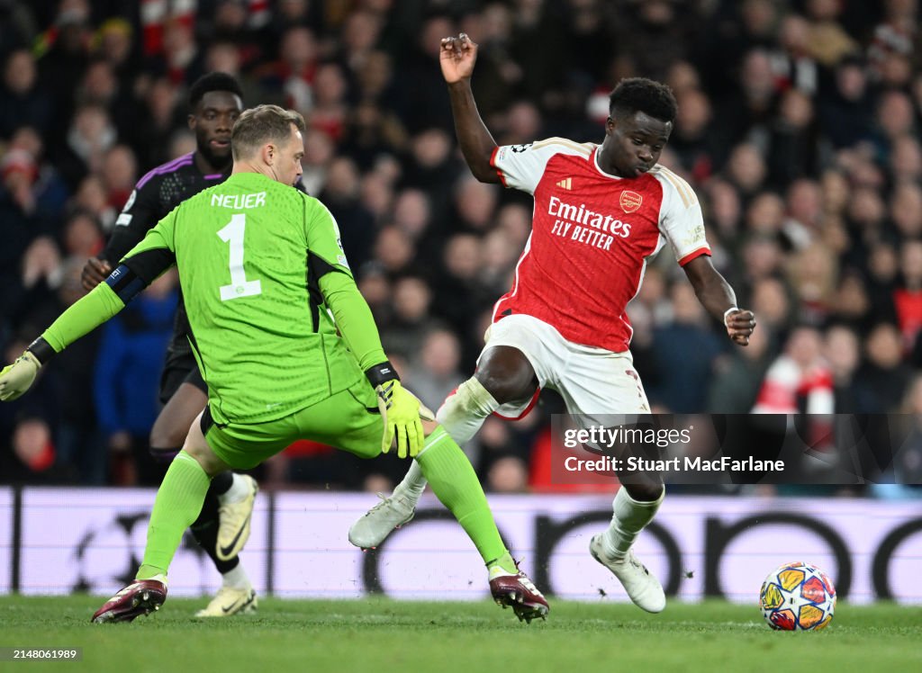 Arsenal's Bukayo Saka goes down after a challenge by <strong><a  data-cke-saved-href='https://www.vavel.com/en-us/soccer/2023/04/18/1144170-real-madrid-look-to-finish-off-chelsea.html' href='https://www.vavel.com/en-us/soccer/2023/04/18/1144170-real-madrid-look-to-finish-off-chelsea.html'>Bayern Munich</a></strong> goalkeeper Manuel Neuer during the UEFA Champions League quarter-final first leg match between Arsenal FC and FC Bayern München at Emirates Stadium on April 09, 2024 in London, England. (Photo by Stuart MacFarlane/Arsenal FC via Getty Images)