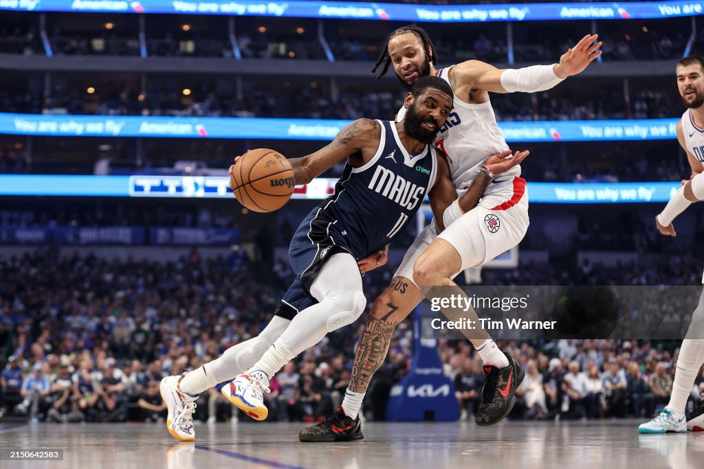DALLAS, TEXAS - APRIL 28: Kyrie Irving #11 of the Dallas Mavericks drives to the basket while defended by Amir Coffey #7 of the Los Angeles Clippers in the first half of game four of the Western Conference First Round Playoffs at American Airlines Center on April 28, 2024 in Dallas, Texas. NOTE TO USER: User expressly acknowledges and agrees that, by downloading and or using this photograph, User is consenting to the terms and conditions of the Getty Images License Agreement. (Photo by Tim Warner/Getty Images)