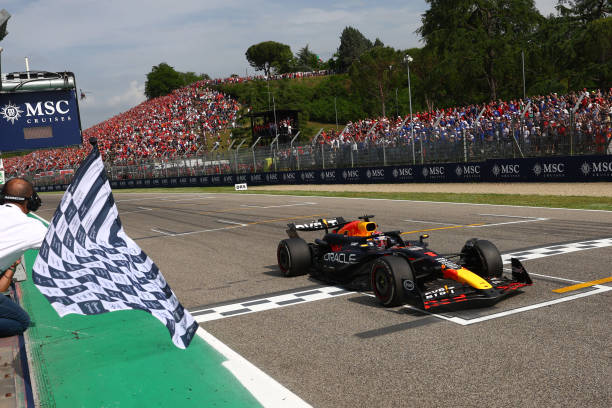 Race winner Max Verstappen of the Netherlands driving the (1) Oracle Red Bull Racing RB20 takes the chequered flag during the F1 Grand Prix of Emilia-Romagna at Autodromo Enzo e Dino Ferrari Circuit on May 19, 2024 in Imola, Italy. (Photo by Clive Rose/Getty Images)