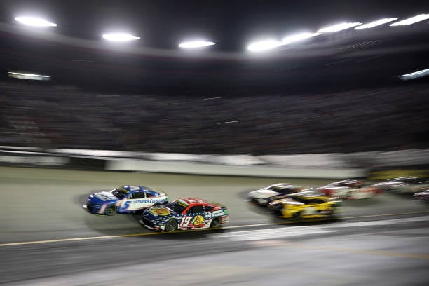 Martin Truex Jr., driver of the #19 Bass Pro Shops Toyota, and Kyle Larson, driver of the #5 HendrickCars.com Chevrolet, race during the NASCAR Cup Series Bass Pro Shops Night Race at Bristol Motor Speedway on September 21, 2024 in Bristol, Tennessee. (Photo by James Gilbert/Getty Images)