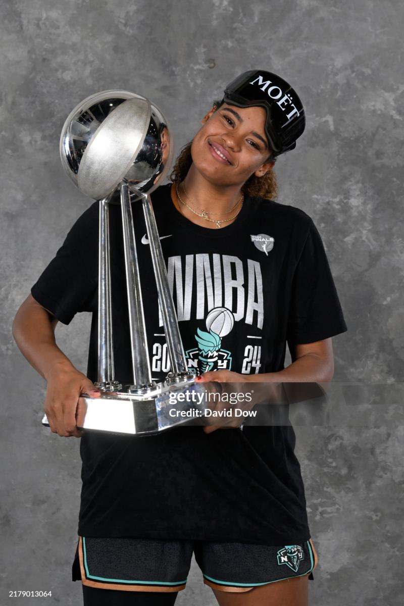 Nyara Sabally #8 of the New York LIberty poses for a portrait with the 2024 WNBA Championship trophy after winning the 2024 WNBA Championship on October 20, 2024 in Brooklyn, New York. NOTE TO USER: User expressly acknowledges and agrees that, by downloading and or using this photograph, user is consenting to the terms and conditions of the Getty Images License Agreement. Mandatory Copyright Notice: Copyright 2024 NBAE (Photo by David Dow/NBAE via Getty Images)