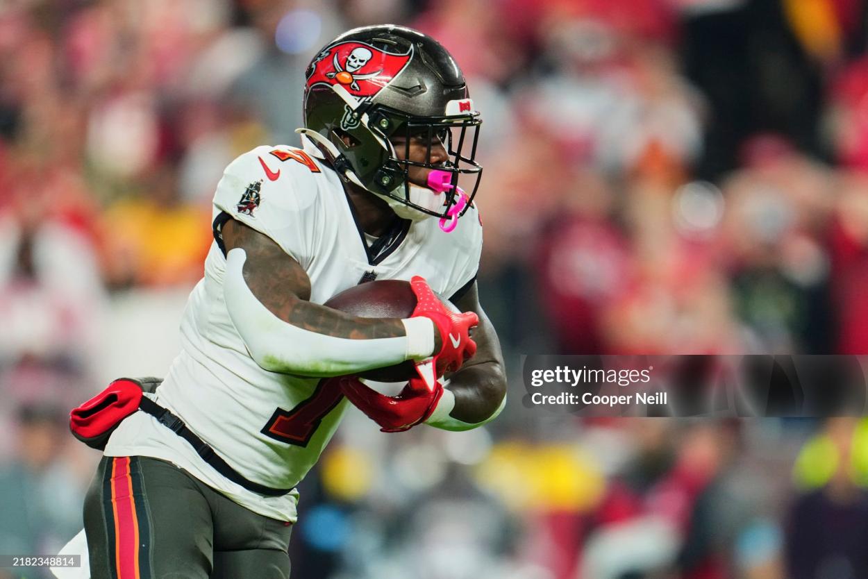 Bucky Irving #7 of the Tampa Bay Buccaneers carries the ball against the Kansas City Chiefs during the first half of an NFL football game at GEHA Field at Arrowhead Stadium on November 4, 2024 in Kansas City, Missouri. (Photo by Cooper Neill/Getty Images)