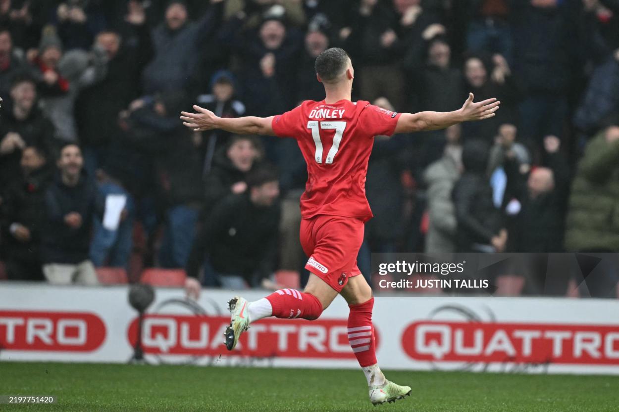 The Leyton Orient #17 English striker Jamie Donley celebrates after his long -distance shot hit the crossbar and is diverted to his own network by German goalkeeper of Manchester City No.18 and Manchester City at the Gaughan Stadium February 8, 2025 