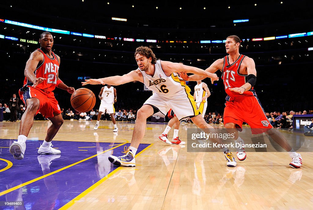 LOS ANGELES, CA - NOVEMBER 29: Pau Gasol #16 of the Los Angeles Lakers reaches for a the ball against Brook Lopez #11 and Bobby Simmons #21 of the New <strong><a  data-cke-saved-href='https://www.vavel.com/en-us/nba/2015/12/23/582576-from-the-outside-looking-in-to-the-outside-looking-within.html' href='https://www.vavel.com/en-us/nba/2015/12/23/582576-from-the-outside-looking-in-to-the-outside-looking-within.html'>Jersey Nets</a></strong> during the second quarter of the NBA basketball game at Staples Center on November 29, 2009 in Los Angeles, California. NOTE TO USER: User expressly acknowledges and agrees that, by downloading and/or using this Photograph, user is consenting to the terms and conditions of the Getty Images License Agreement. (Photo by Kevork Djansezian/Getty Images)