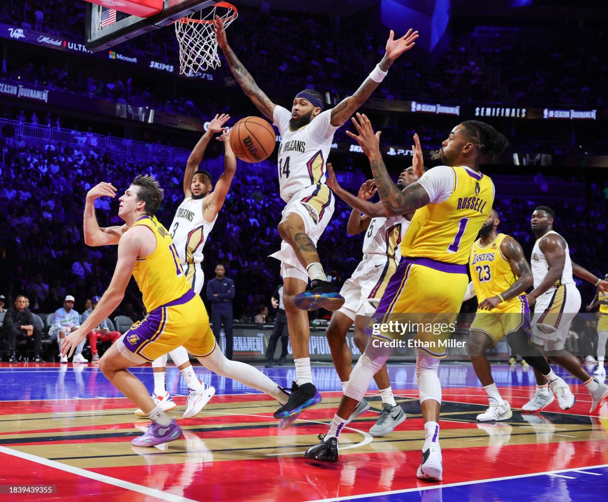 Austin Reaves #15 of the Los Angeles Lakers tries to pass the ball behind him to D'Angelo Russell #1 as Brandon Ingram #14 of the New Orleans Pelicans defends in the first half of the West semifinal game of the inaugural NBA In-Season Tournament at T-Mobile Arena on December 07, 2023 in Las Vegas, Nevada. The Lakers defeated the Pelicans 133-89. NOTE TO USER: User expressly acknowledges and agrees that, by downloading and or using this photograph, User is consenting to the terms and conditions of the Getty Images License Agreement. (Photo by Ethan Miller/Getty Images)