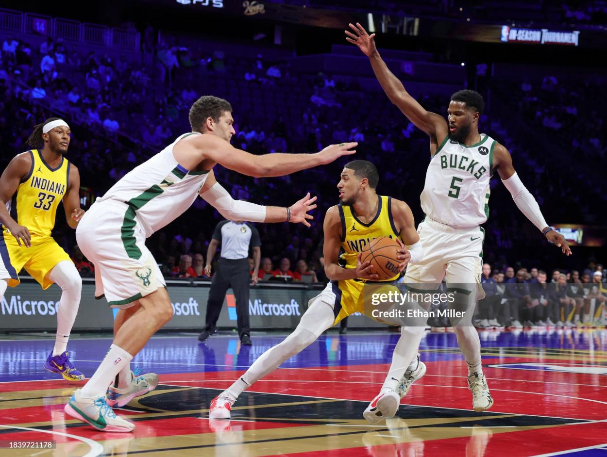 Tyrese Haliburton #0 of the Indiana Pacers is guarded by Brook Lopez #11 and Malik Beasley #5 of the Milwaukee Bucks in the first half of the East semifinal game of the inaugural NBA In-Season Tournament at T-Mobile Arena on December 07, 2023 in Las Vegas, Nevada. The Pacers defeated the Bucks 128-119. NOTE TO USER: User expressly acknowledges and agrees that, by downloading and or using this photograph, User is consenting to the terms and conditions of the Getty Images License Agreement. (Photo by Ethan Miller/Getty Images)