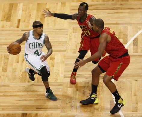 Celtics Guard Isaiah Thomas tries to get past Atlanta's defenders guard Dennis Schroder and Center Al Horford 