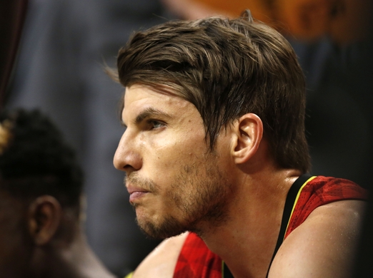 Guard Kyle Korver takes a rest and looks on from the bench.