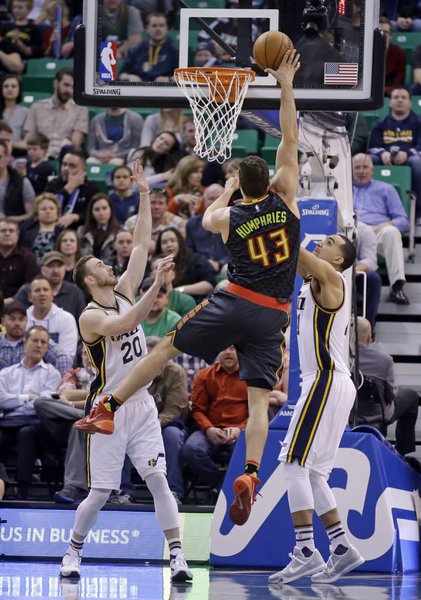 Atlanta Hawks' Kris Humphries takes a shot defended by Utah Jazz's Gordon Hayward and Trey Lyles. | Associated Press