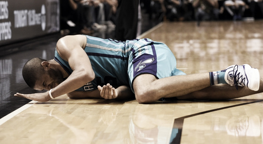 Charlotte Hornets Guard Nicolas Batum lays on the floor after spraining his left ankle. Steve Mitchell-USA TODAY Sports  