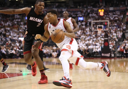 Toronto Raptors Guard Kyle Lowry drives to the basket against Miami Heat forward Joe Johnson. Photo Credit:Tom Szczerbowski-USA TODAY Sports  