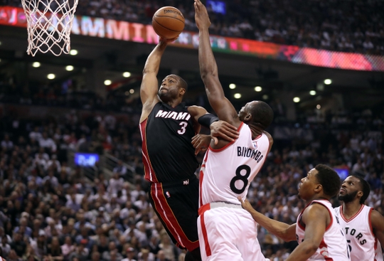 Miami Heat Guard Dwayne Wade attacks the basket before getting blocked by Toronto Raptors center Bismack Biyombo. Photo Credit:Tom Szczerbowski-USA TODAY Sports 