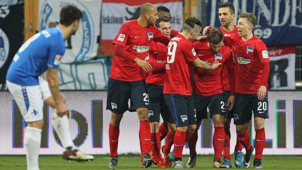 Plattenhardt is surrounded by his teammates following his stunning freekick in the earlier fixture (Image Source: Sportschau.de) 