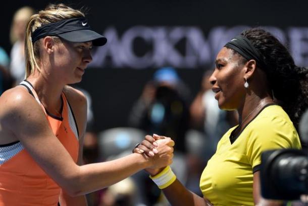 Serena Williams and Maria Sharapova meet at the net after their match|Photo: Saeed Khan/Getty Images