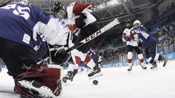 Canada's Jennifer Wakefield tries to get the puck past USA's goalie Maddie Rooney in the women's gold medal ice hockey match between Canada and the U.S. at the Pyeongchang 2018 Winter Olympic Games. | Photo: AFP/Getty Images