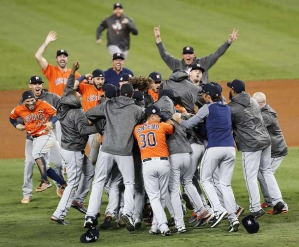 The Astros pour onto the field after winning the World Series/Photo: Brett Coomer/Houston Chronicle