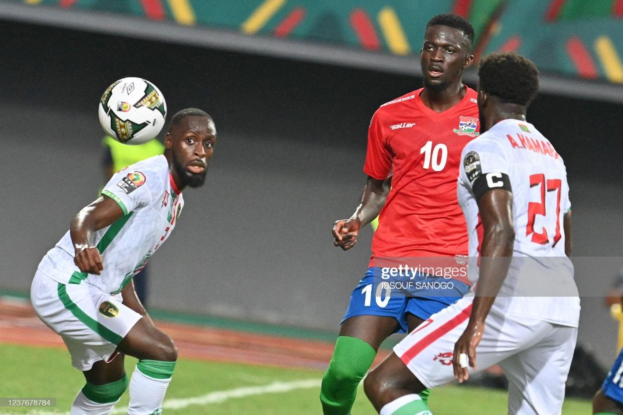 Mauritania's defender Souleymane Karamoko (L) eyes the ball past Gambia's midfielder Musa Barrow during the Group F Africa Cup of Nations (CAN) 2021 football match between Mauritania and Gambia at Limbe Omnisport Stadium in Limbe on January 12, 2022. (Photo by Issouf SANOGO / AFP) (Photo by ISSOUF SANOGO/AFP via Getty Images)