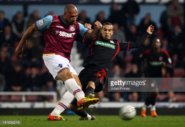 Seb Hines puts pressure on John Carew during Boro's last league meeting with West Ham | Photo: Getty