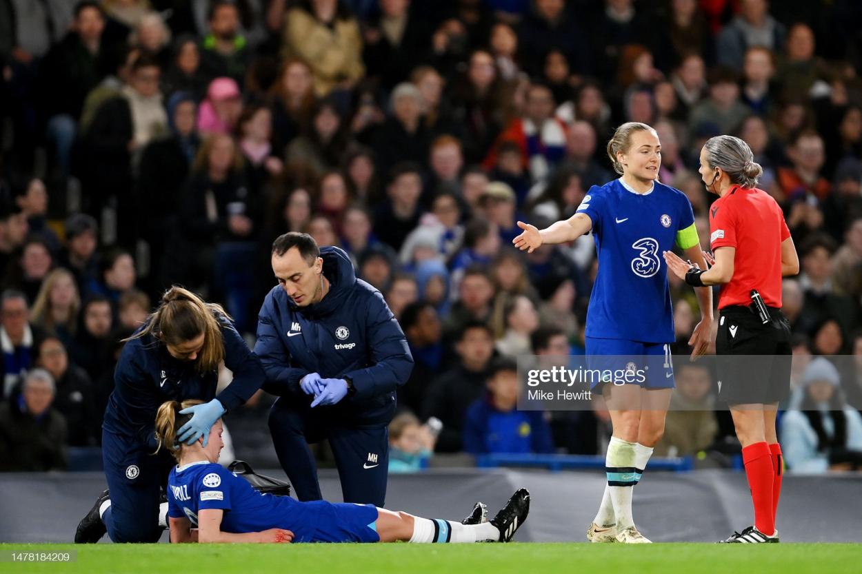 <strong><a  data-cke-saved-href='https://www.vavel.com/en/football/2021/05/04/womens-football/1070036-tottenham-women-vs-chelsea-womens-super-league-preview-team-news-predicted-line-ups-ones-to-watch-and-how-to-watch.html' href='https://www.vavel.com/en/football/2021/05/04/womens-football/1070036-tottenham-women-vs-chelsea-womens-super-league-preview-team-news-predicted-line-ups-ones-to-watch-and-how-to-watch.html'>Melanie Leupolz</a></strong> of Chelsea receives medical treatment as Magdalena Eriksson of Chelsea speaks with match referee Ivana Martincic during the UEFA Women's <strong><a  data-cke-saved-href='https://www.vavel.com/en/football/2023/03/30/womens-football/1142204-vfl-wolfsburg-vs-psguefa-womens-champions-league-preview-quarter-final-second-leg-2023.html' href='https://www.vavel.com/en/football/2023/03/30/womens-football/1142204-vfl-wolfsburg-vs-psguefa-womens-champions-league-preview-quarter-final-second-leg-2023.html'>Champions League</a></strong> quarter-final 2nd leg match between Chelsea FC and Olympique Lyonnais at <strong><a  data-cke-saved-href='https://www.vavel.com/en/football/2023/03/22/womens-football/1141484-emma-hayes-is-satisfied-after-blues-take-the-lead-against-lyon-in-the-first-leg-of-the-champions-league-quarter-finals.html' href='https://www.vavel.com/en/football/2023/03/22/womens-football/1141484-emma-hayes-is-satisfied-after-blues-take-the-lead-against-lyon-in-the-first-leg-of-the-champions-league-quarter-finals.html'>Stamford Bridge</a></strong> on March 30, 2023 in London, England. (Photo by Mike Hewitt/Getty Images)