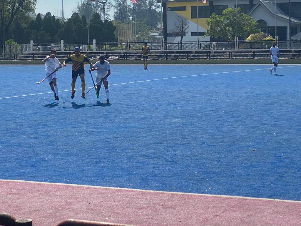 Jaspreet Singh and Melvinder Singh from Singapore (in white) challenging a Negeri Sembilan player (in yellow) for the ball