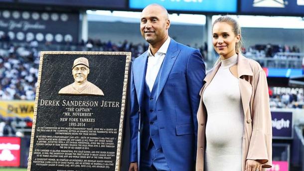 Jeter and wife Hannah Davis pose with the Yankee great's plaque on the field during a pregame ceremony honoring the former shortstop/Photo: Al Bello/Getty Images