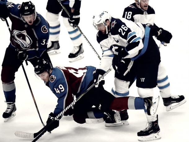 Sam Girard (49) of the Avalanche tried to force his way through the Jet's defense. (AP Photo/David Zalubowski