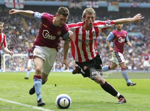 BIRMINGHAM, UNITED KINGDOM - MAY 07: James Milner of Villa holds off Danny Colins of Sunderland during the Barclays Premiership match between Aston Villa and Sunderland at Villa Park on May 7, 2006 in Birmingham, England. (Photo by Jamie McDonald/Getty Images)