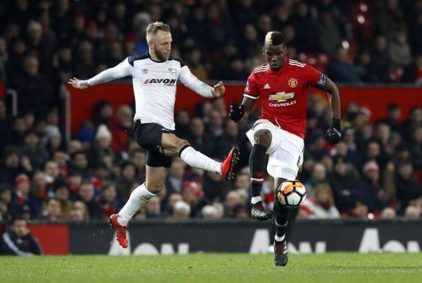 Johnny Russell taking on Paul Pogba | Source: The Associated Press