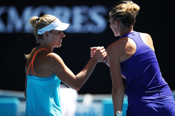 Kerber and Pliskova shake hands at the net following their round match (Photo by Clive Brunskill / Getty Images)