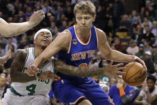 New York Knicks Forward Mindaugas Kuzminskas (91) holds the ball against Boston Celtics guard Isaiah Thomas. Photo courtesy of   David Butler II-USA TODAY Sports. 