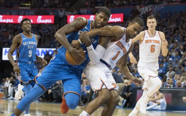 New York Knicks PG Ramon Sessions (1) attempts to steal the ball from Oklahoma City Thunder SF Paul George (13). Photo:AP/Sue Ogrocki 