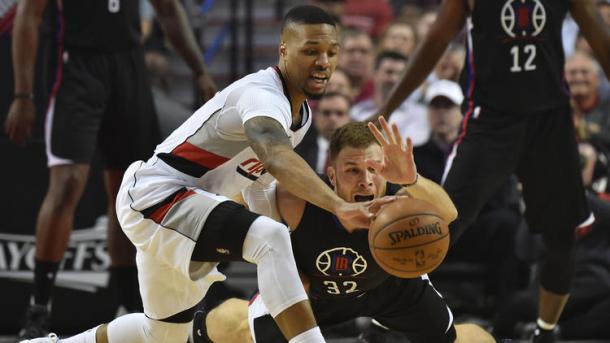 Blake Griffin and Damian Lillard fight for the ball (Steve Dykes/Getty Images)