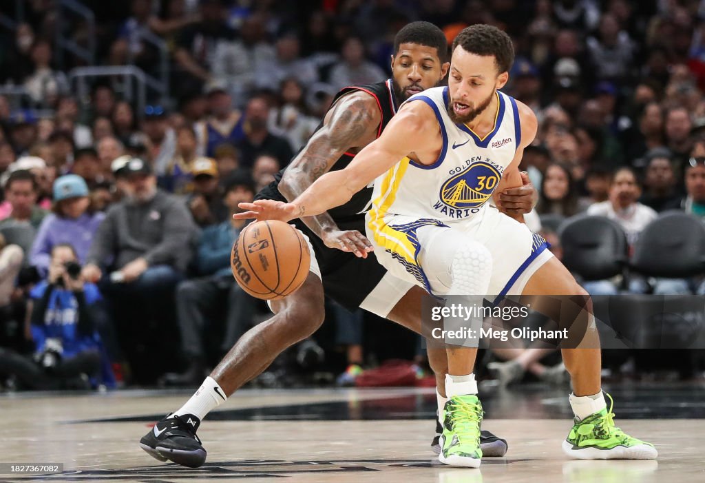 Stephen Curry #30 of the <strong><a  data-cke-saved-href='https://www.vavel.com/en-us/nba/2023/10/24/1160301-phoenix-suns-vs-golden-state-warriors-preview-the-nba-is-back-in-action.html' href='https://www.vavel.com/en-us/nba/2023/10/24/1160301-phoenix-suns-vs-golden-state-warriors-preview-the-nba-is-back-in-action.html'>Golden State</a></strong> Warriors handles the ball defended by <strong><a  data-cke-saved-href='https://www.vavel.com/en-us/nba/2023/12/03/1165120-paul-george-confident-on-clippers-current-situation.html' href='https://www.vavel.com/en-us/nba/2023/12/03/1165120-paul-george-confident-on-clippers-current-situation.html'>Paul George</a></strong> #13 of the LA Clippers in the fourth quarter at Crypto.com Arena on December 02, 2023 in Los Angeles, California. NOTE TO USER: User expressly acknowledges and agrees that, by downloading and or using this photograph, User is consenting to the terms and conditions of the Getty Images License Agreement. (Photo by Meg Oliphant/Getty Images)