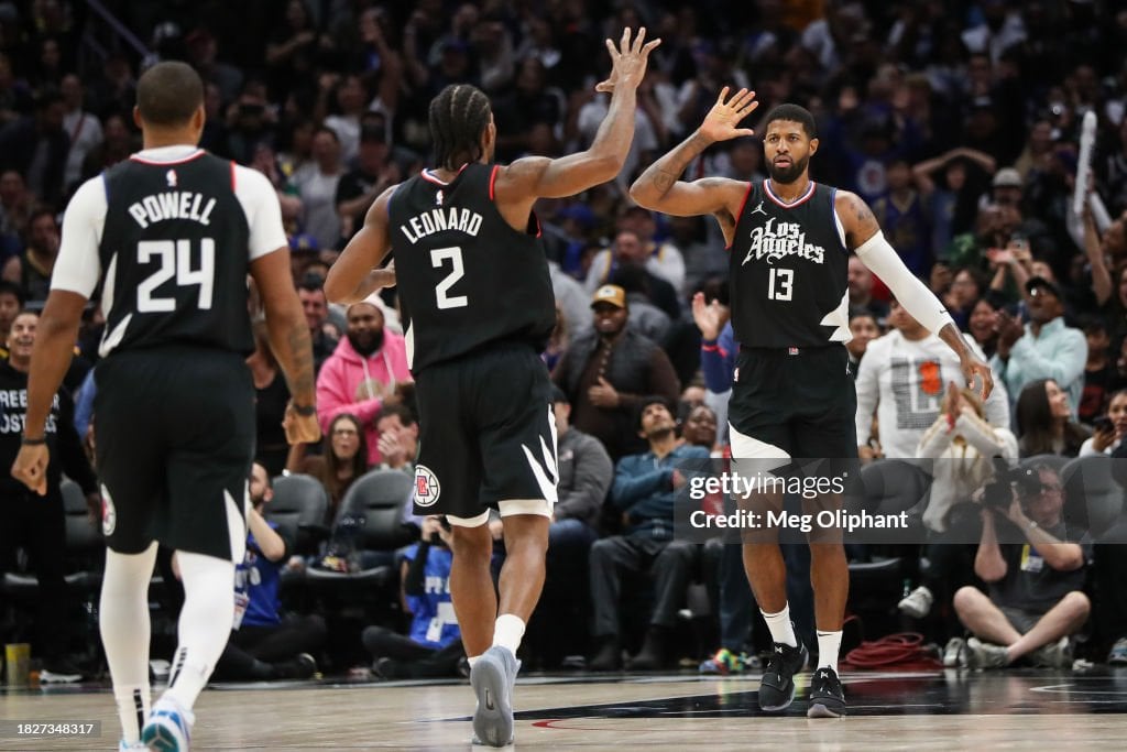 Paul George #13 of the LA Clippers reacts to his shot in the end of the fourth quarter against the <strong><a  data-cke-saved-href='https://www.vavel.com/en-us/nba/2023/10/30/1161140-golden-state-warriors-vs-new-orleans-pelicans-preview-the-bay-wants-to-take-away-the-unbeaten-streak.html' href='https://www.vavel.com/en-us/nba/2023/10/30/1161140-golden-state-warriors-vs-new-orleans-pelicans-preview-the-bay-wants-to-take-away-the-unbeaten-streak.html'><strong><a  data-cke-saved-href='https://www.vavel.com/en-us/nba/2023/10/24/1160301-phoenix-suns-vs-golden-state-warriors-preview-the-nba-is-back-in-action.html' href='https://www.vavel.com/en-us/nba/2023/10/24/1160301-phoenix-suns-vs-golden-state-warriors-preview-the-nba-is-back-in-action.html'>Golden State</a></strong> Warriors</a></strong> with <strong><a  data-cke-saved-href='https://www.vavel.com/en-us/nba/2023/11/25/1164109-gregg-popovichinterrupts-match-takes-microphone-and-asks-fans-not-to-boo-opposing-player.html' href='https://www.vavel.com/en-us/nba/2023/11/25/1164109-gregg-popovichinterrupts-match-takes-microphone-and-asks-fans-not-to-boo-opposing-player.html'>Kawhi Leonard</a></strong> #2 at Crypto.com Arena on December 02, 2023 in Los Angeles, California. NOTE TO USER: User expressly acknowledges and agrees that, by downloading and or using this photograph, User is consenting to the terms and conditions of the Getty Images License Agreement. (Photo by Meg Oliphant/Getty Images)