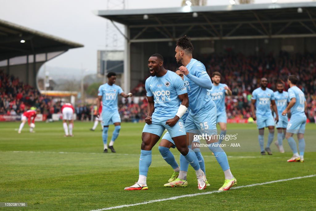 Lee Ndlovu of Boreham Wood celebrates after scoring a goal to make it 0-1 during the <strong><a href='https://www.vavel.com/en/football/2023/04/28/1145211-give-the-fans-what-they-deserve-luke-williams-previews-york-clash.html'>Vanarama National League</a></strong> match between Wrexham and Boreham Wood at <strong><a href='https://www.vavel.com/en/football/2023/03/25/1141785-wrexham-3-0-york-city-minstermen-mastered-by-rampant-reds.html'>Racecourse Ground</a></strong> on April 22, 2023 in Wrexham, Wales. (Photo by Matthew Ashton - AMA/Getty Images)