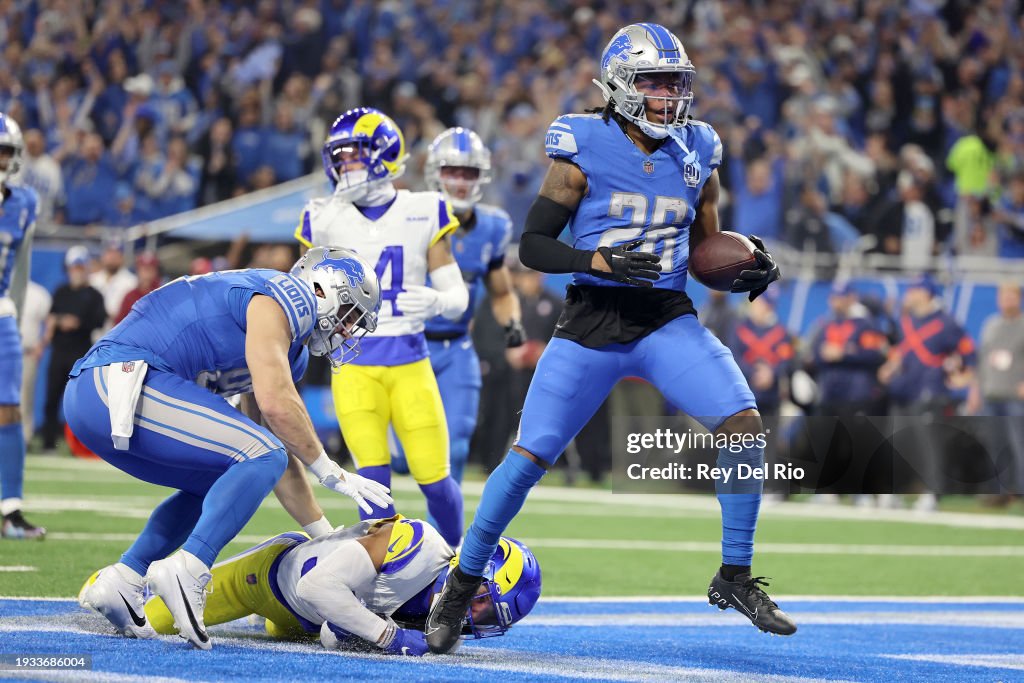 Jahmyr Gibbs #26 of the Detroit Lions runs the ball for a touchdown against Quentin Lake #37 of the Los Angeles Rams during the first quarter in the NFC Wild Card Playoffs at Ford Field on January 14, 2024 in Detroit, Michigan. (Photo by Rey Del Rio/Getty Images)