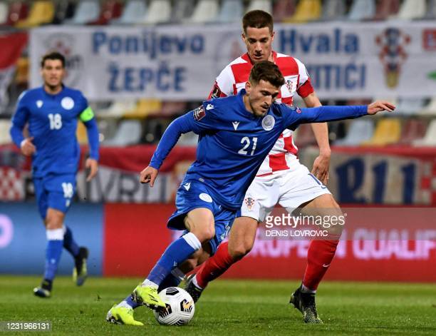 Cyprus' forward Marinos Tzionis (L) fights for the ball with Croatia's midfielder Mario Pasalic during the FIFA World Cup Qatar 2022 qualification Group H football match between Croatia and Cyprus at the HNK Rijeka Stadium, in Rijeka, on March 27, 2021. (Photo by Denis LOVROVIC / AFP) (Photo by DENIS LOVROVIC/AFP via Getty Images)