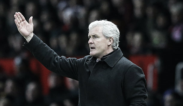 Mark Hughes looks on in anger as his side lose 3-0 with a place in Europe clinging to a thread (image: getty)