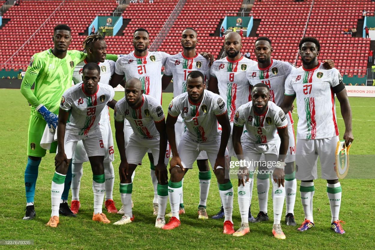 (FromL) Back row: Mauritania's players, goalkeeper Babacar Diop, forward Pape Ibnou Ba, defender El Hassen Houebib, midfielder Abdallahi Mahmoud, midfielder Guessouma Fofana, midfielder Mohamed Yali Dellahi forward Aboubakar Kamara; (front row): defender Abdoulkader Thiam, midfielder Almike Moussa N'Diaye, defender Aly Abeid and defender Souleymane Karamoko pose before the Group F Africa Cup of Nations (CAN) 2021 football match between Mauritania and Gambia at Limbe Omnisport Stadium in Limbe on January 12, 2022. (Photo by Issouf SANOGO / AFP) (Photo by ISSOUF SANOGO/AFP via Getty Images)
