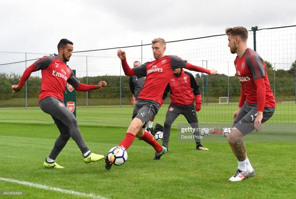 ST ALBANS, ENGLAND - SEPTEMBER 16: Theo Walcott and Per Mertesacker of Arsenal during Arsenal 1st team training session at London Colney on September 16, 2017 in St Albans, England. (Photo by David Price/Arsenal FC via Getty Images)