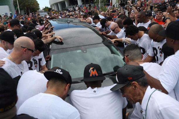 Jose Fernandez's teammates pray as his body is transported to a local church for a public visatation-Miami Dade County
