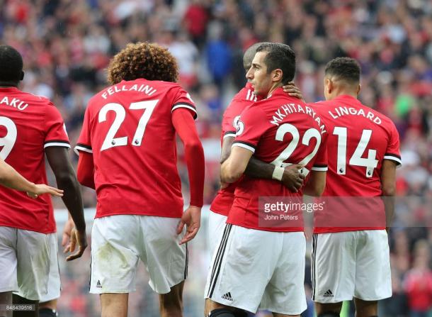 Henrikh Mkhitaryan is congratulated by his teammates for his goal against Everton. (Photo credit: John Peters/Getty Images)