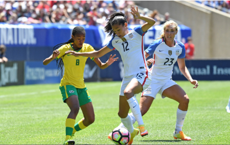 Motlhalo (#8) waits to attack United States midfielder Christen Press (#12) while midfielder Allie Long (#23) provides support. | Photo: Patrick Gorski - Icon Sportswire via Getty Images