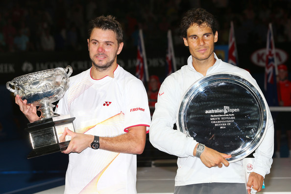 Wawrinka and Nadal holding their respective trophies following their clash in the final of the Australian Open in 2014 (Photo by Mark Kolbe / Getty Images) 