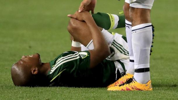 Nagbe clutches his leg after De Jong's late challenge. (Source: Sean M. Haffey/Getty Images)