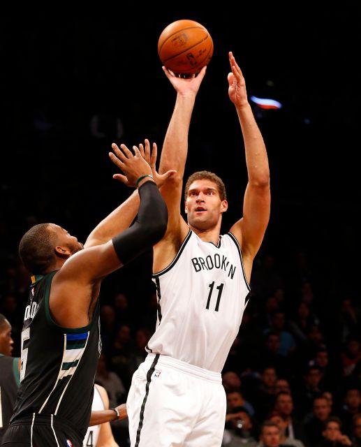 Brooklyn Nets center Brook Lopez(11) shots over Milwaukee Bucks forward Greg Monroe (15). Photo by Jim McIsaac/newsday.