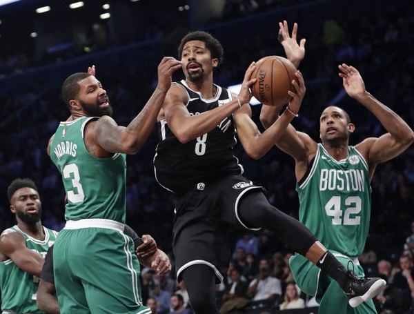 Brooklyn Nets' Spencer Dinwiddie (8) makes a pass while Boston Celtics Al Horford (42) and Marcus Morris (13) defend him. Photo: AP Photo/Frank Franklin II)