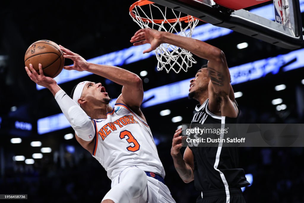 Josh Hart #3 of the New York Knicks is defended by Nic Claxton #33 of the Brooklyn Nets during the fourth quarter of the game at Barclays Center on January 23, 2024 in the Brooklyn borough of New York City. NOTE TO USER: User expressly acknowledges and agrees that, by downloading and or using this photograph, User is consenting to the terms and conditions of the Getty Images License Agreement. (Photo by Dustin Satloff/Getty Images)