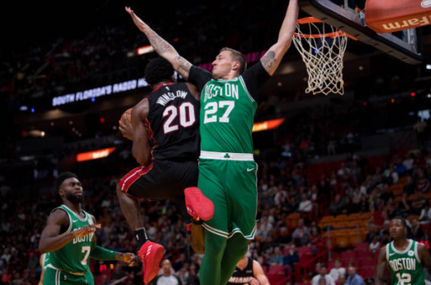 Justise Winslow  of the Miami Heat drives past Daniel Theis of the Boston Celtics during the game at the American Airlines Arena on October 28, 2017 in Miami, Florida. Photo by Rob Foldy/Getty Images